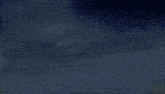 a blurry image of a blue and red object with a blue sky in the background