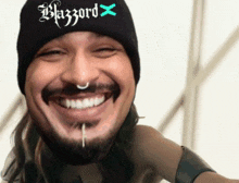 a man with a beard wearing a beanie that says blazord on it