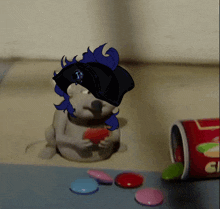 a cartoon drawing of a hamster eating a heart next to a container of candy