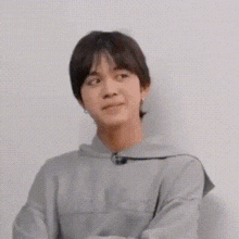 a close up of a person 's face with a hoodie on .