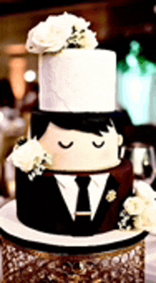 a wedding cake with a bride and groom on it .