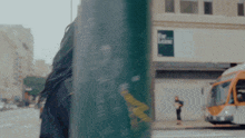 a blurry picture of a woman walking down a street with a sign that says the lane on it