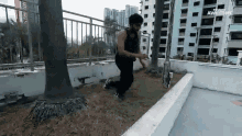 a man is doing a trick on a ledge in front of a building with the word awkward on the bottom