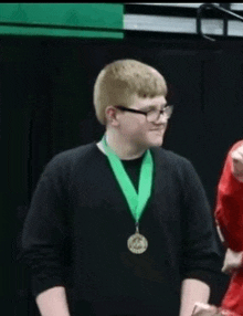 a young man is wearing a medal around his neck .