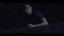 a man in a blue shirt with flames coming out of his head