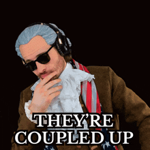 a man wearing a wig and headphones is standing in front of a sign that says they 're coupled up