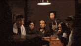 a group of people sitting around a table with the words those bastards should be buried alive
