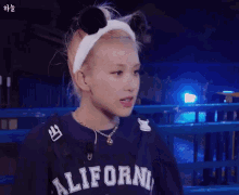 a girl wearing a headband and a california sweatshirt