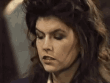 a close up of a woman 's face with a serious expression