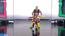 a man and a woman are dancing on a stage in front of a screen that says the king
