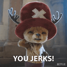 a stuffed animal with antlers and a hat that says you jerks on it