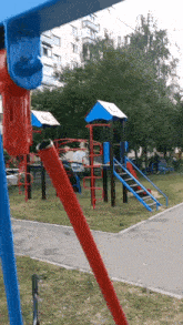 a blue and red playground with a blue slide