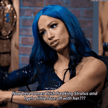 a woman with blue hair says now here comes trish freaking stratus and i get a little face off with her ??