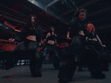a group of women are dancing in a dark room with a sign above them that says 8888