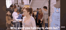 a woman is talking to a man in a crowd of people .