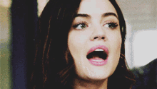 a close up of a woman with her mouth wide open