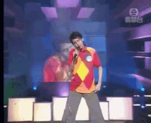 a man singing into a microphone on a stage with the number 8 on the bottom