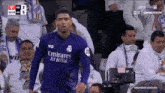 a soccer player wearing an emirates fly better jersey
