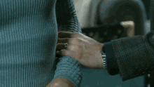 a man and a woman are looking at each other in a room
