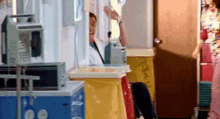 a man is sitting in a hospital room holding an iv .