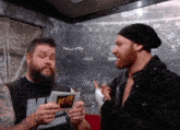 a man with a beard holds a piece of paper that says md
