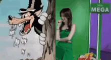 a woman in a green dress stands next to a cartoon wolf and a sign that says mega