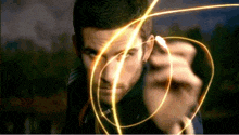 a close up of a man 's face with a glowing swirl around it
