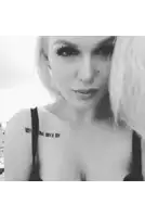 a woman with a tattoo on her shoulder that says iv om ivx iv