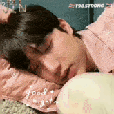 a young man is sleeping on a pillow with the words good night written on the bottom