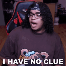 a man with curly hair wearing glasses and a bandana says " i have no clue "