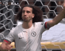 a soccer player in a white shirt with the word chelsea on it