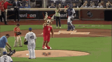 a baseball player with the number 40 on his back stands on the field