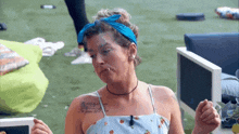 a woman wearing a blue headband has a tattoo on her arm