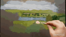 a person is painting a landscape with the words made in animotica visible