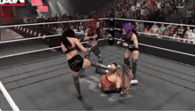 a group of female wrestlers are fighting in a ring .