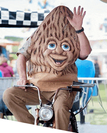 a man in a mushroom costume is riding a bike