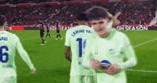 a group of soccer players are on a field and one of them has the number 1 on his jersey