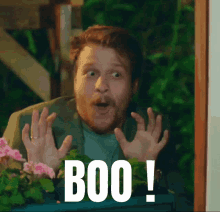 a man with a surprised look on his face and the word boo on the bottom right