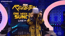 a man wearing a hat is standing in front of a sign that says aew revolution live on .