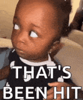 a baby is making a funny face with the words `` that 's been hit '' written above it .