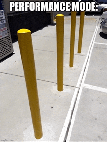 a row of yellow poles in a parking lot with the words performance mode above them