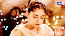a vaseline ad features a woman in a white dress
