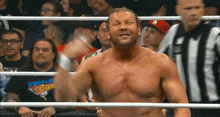 a man in a crop king shirt is standing in a ring