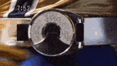 a close up of a belt with the time 7:52