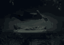 a person in a red dress is flying over a person laying in a bed