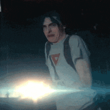 a man wearing a white shirt with a red triangle on the front