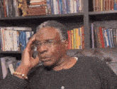 a man in front of a bookshelf with a book titled animal break