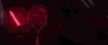 a close up of a man 's face with a red light coming out of his mouth .