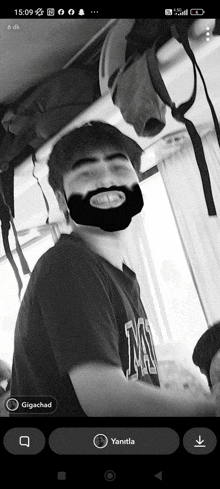 a black and white photo of a man with a beard is displayed on a phone screen