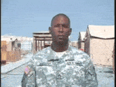 a man in a u.s. army uniform stands in front of a tent